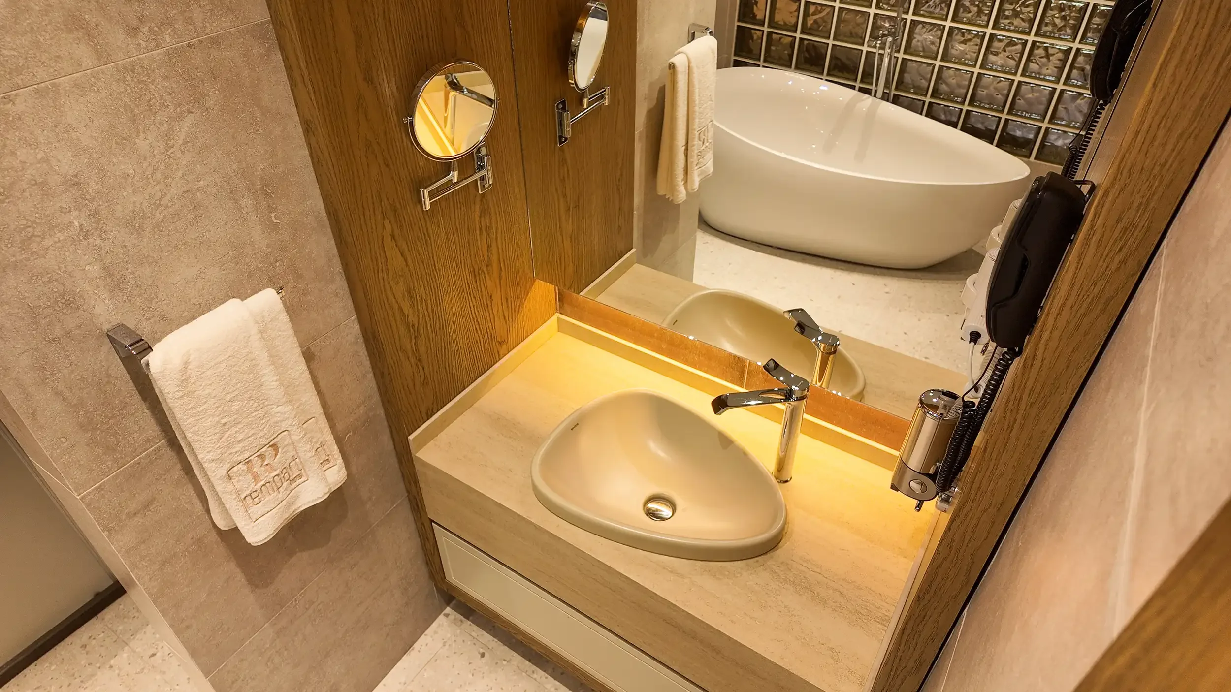 Rempart Hotel ortak alanlarında kemerli mimari geçişler, sıcak tavan aydınlatmaları, doğal taş ve ahşap yüzeylerin birlikte kullanıldığı çağdaş butik otel dili, NDO Mimarlık